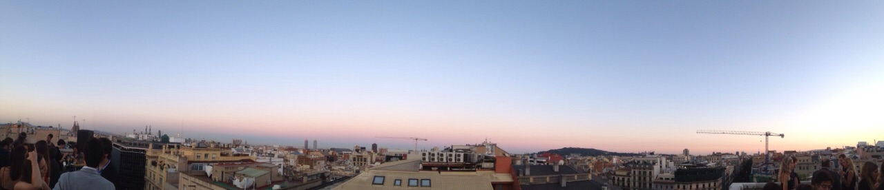 View of town buildings at night under a purple and pink sky.