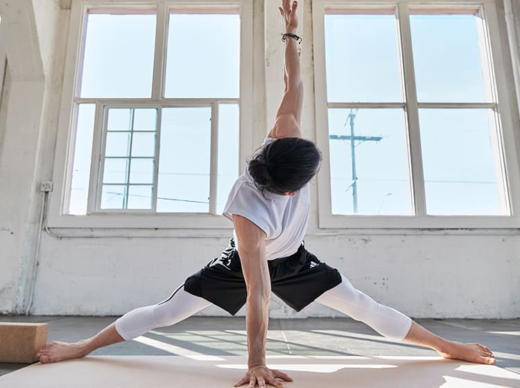 Man poses powerfully in yoga.